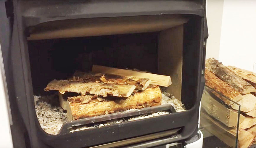 Woodstack in fireplace. Photo.