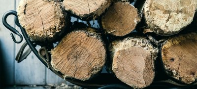 Woodlogs in basket. Photo.