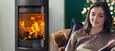Woman in front of her fireplace at Christmas