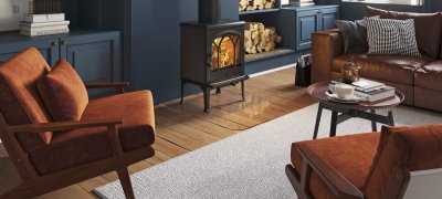 Jøtul F 200 black wood burning stove in a dark blue living room