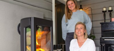 To women standing in front of their wood stove Jøtul F 167
