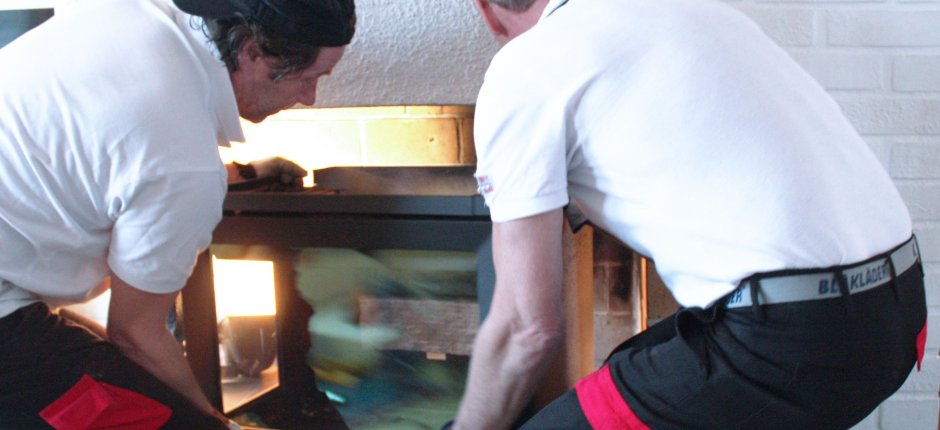 Men installing an insert. Photo.