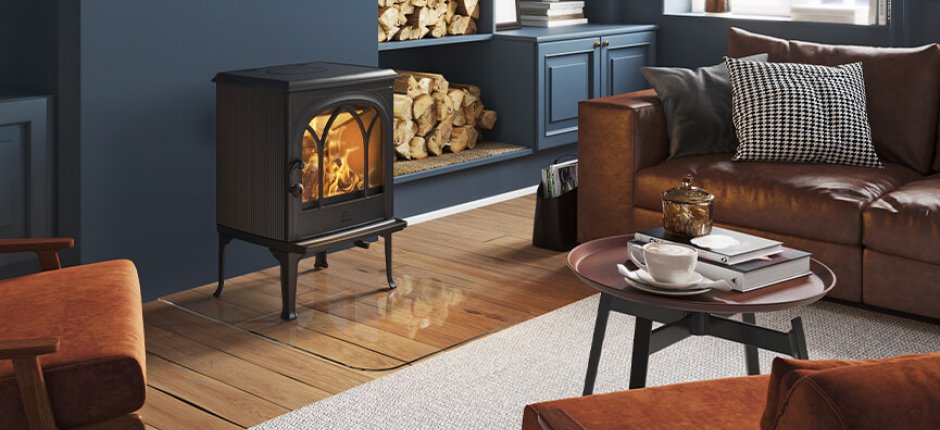 Jøtul F 200 black wood burning stove in a dark blue living room
