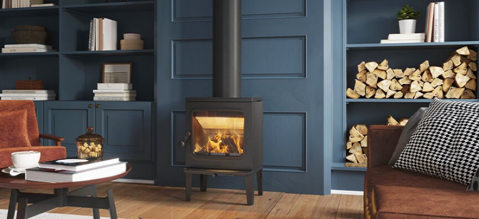Jøtul F 205 black wood burning stove in a dark blue living room