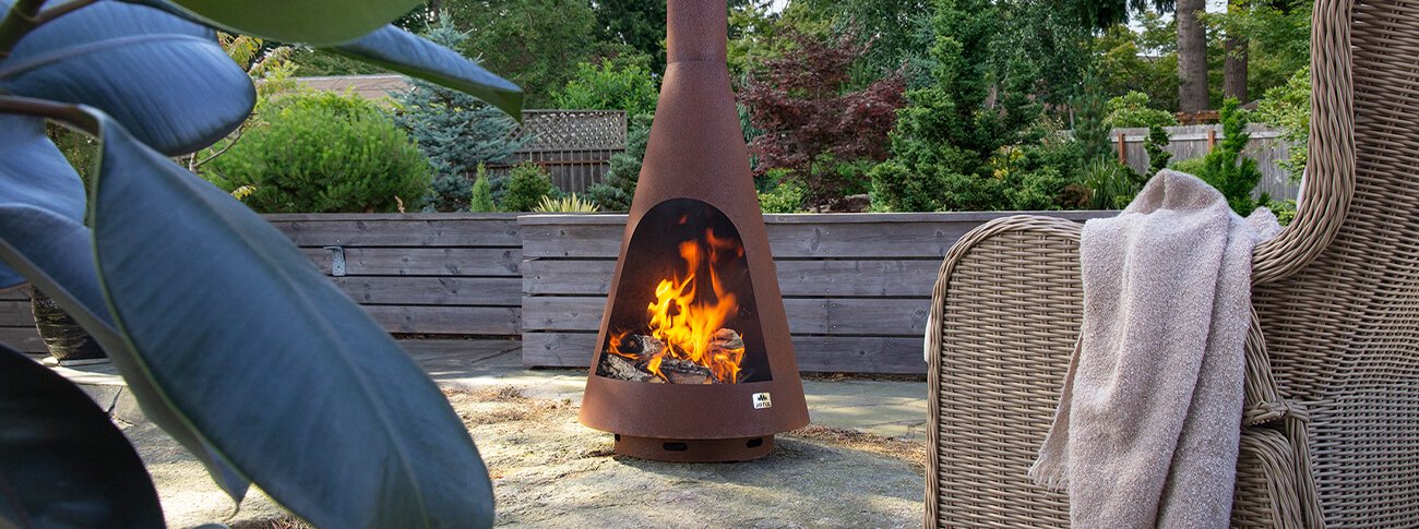Jøtul Frøya brown color outdoor fireplace in the garden