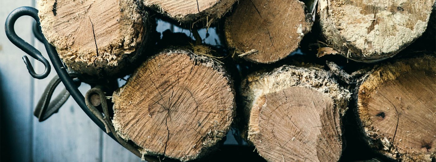Woodlogs in basket. Photo.