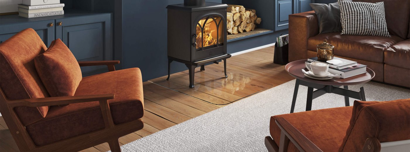 Jøtul F 200 black wood burning stove in a dark blue living room