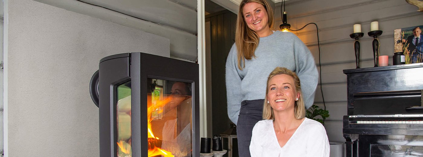 To women standing in front of their wood stove Jøtul F 167