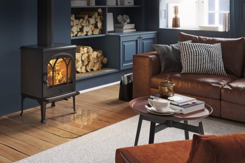 Jøtul F 200 black and small wood burning stove in a dark blue living room