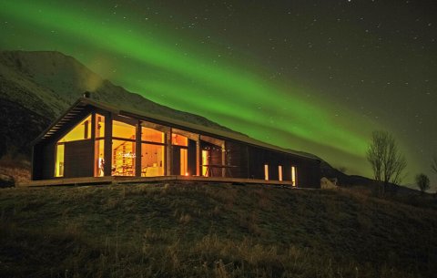 Modern cabin with Northern Lights.